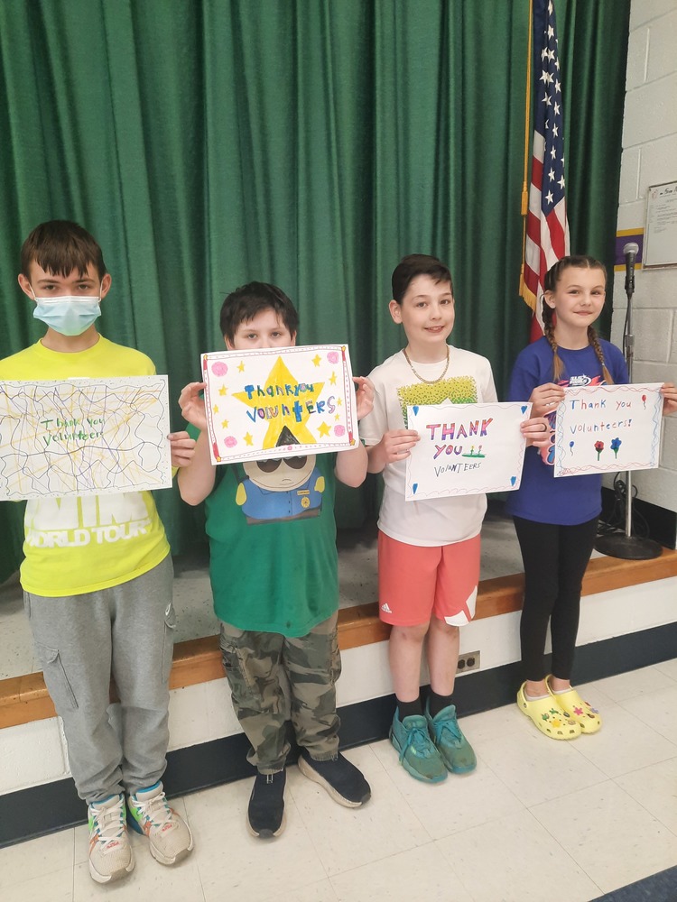 Students hold up placemats