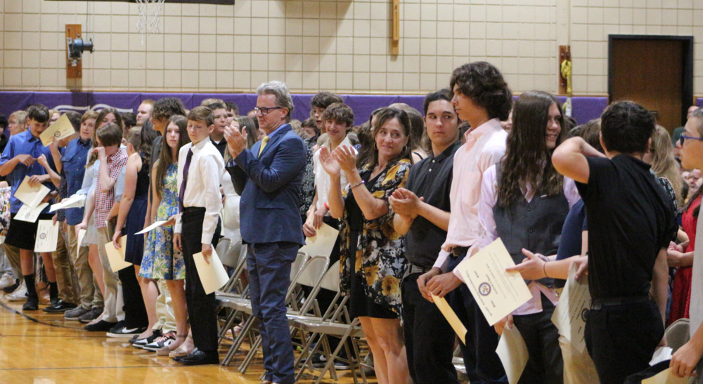 Students and teachers stand during the 8th Grade Recognition Ceremony at Springville Middle School