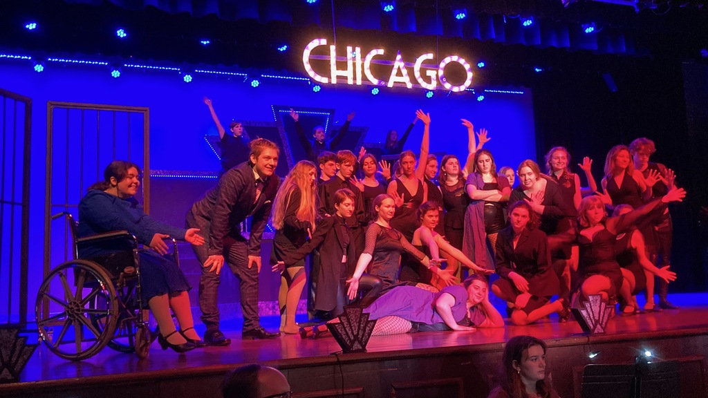 A group shot underneath  a CHICAGO sign.
