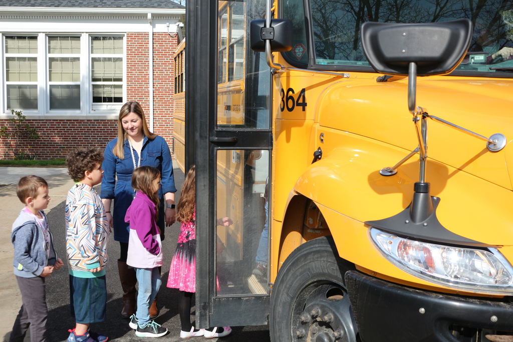 Students boarding a bus at Colden Elementary School for a bus drill. 