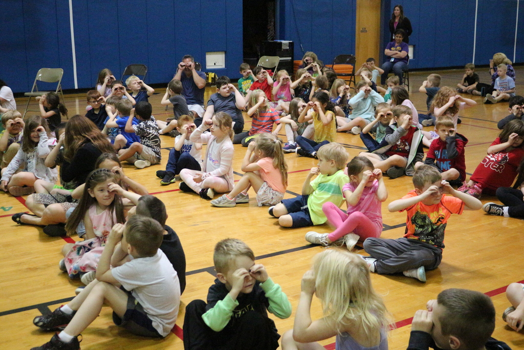 Students participate in an exercise during a presentation from Hawk Creek Wildlife Center. 