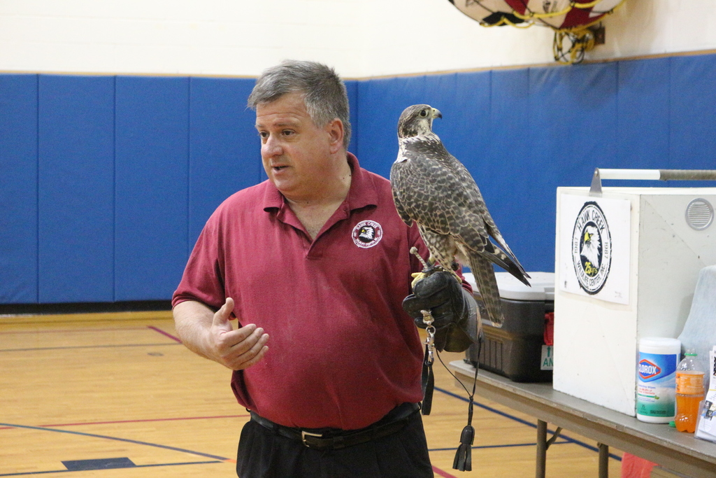 Matt Zymanek teaches students about a falcon.